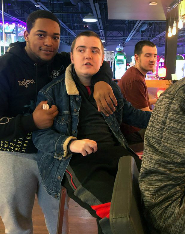 Above left: NHR Direct Support Professional Ma'leec Johnson with brothers Shawn and Frankie McCann as they get ready for a snack.